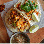Mexico City street food guide 2026 — tacos al pastor carved from trompo at night CDMX