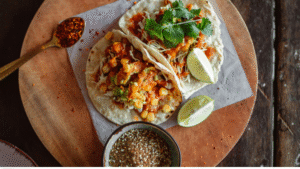 Mexico City street food guide 2026 — tacos al pastor carved from trompo at night CDMX