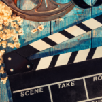 A film clapperboard and reel representing actor Abhirup Chakraborty’s journey in cinema and advertisements.