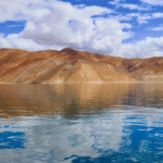 Ladakh-monsoon-travel-guide-2026-—-Pangong-Lake-clear-blue-sky-snowcapped-mountains