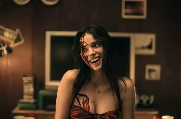 Nikki covered in blood, signalling the ultimate loss of her bodily autonomy due to obsession.