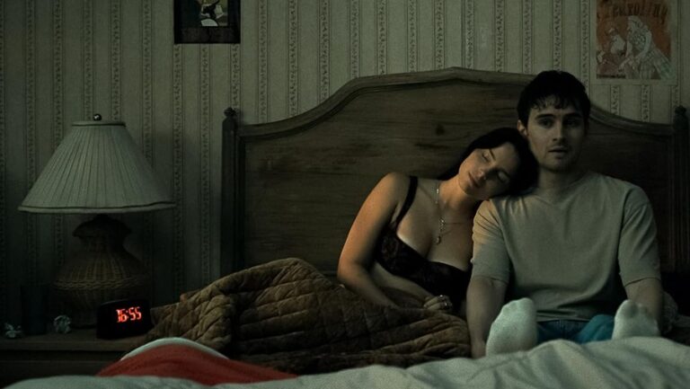 Nikki and Bear in a still from the film, illustrating the quiet tension at the heart of Obsession.