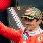 Charles Leclerc celebrates with the winner's trophy after securing a dramatic British Grand Prix victory at Silverstone, marking Ferrari's 250th Formula One Grand Prix win.