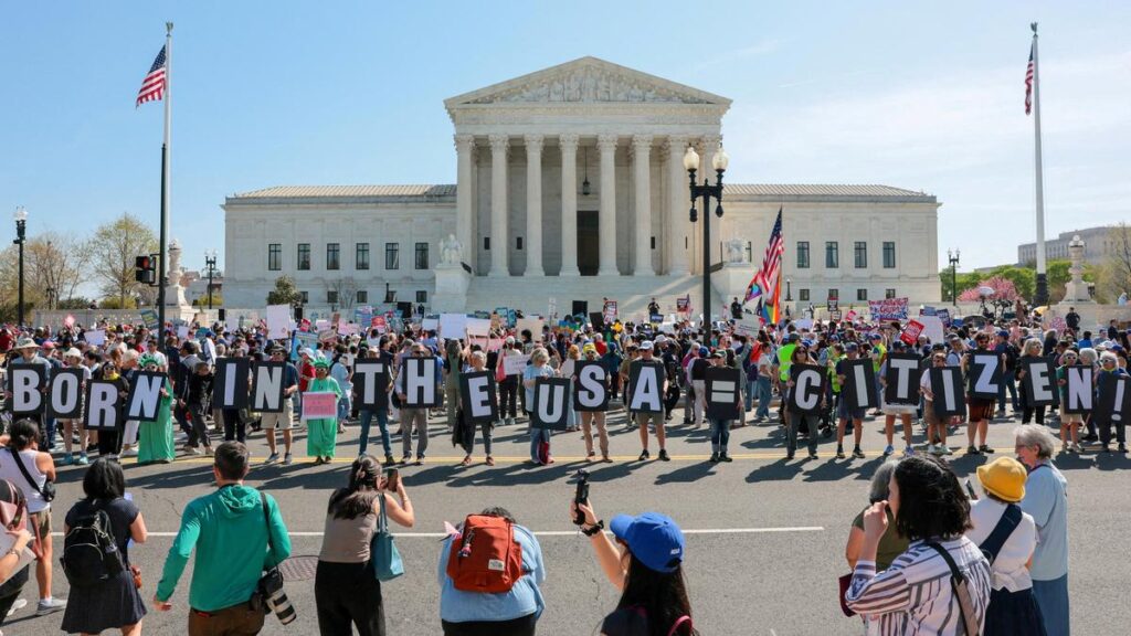 Demonstrators outside the U.S. Supreme Court holding “BORN IN THE USA = CITIZEN!” in a birthright citizenship protest.