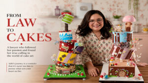 Chef Aditi posing with her custom-designed cakes as a professional cake artist.